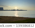 Serene sunrise over tropical ocean with beach and resort 139386812
