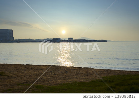 Serene sunrise over tropical ocean with beach and resort 139386812