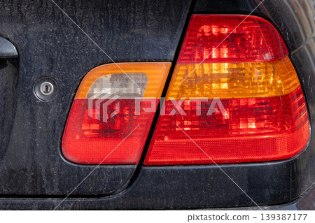Bright lights from car headlights shine in a parking lot after sunset as vehicles are parked and the city sleeps Bright lights from car headlights shine in a parking lot after sunset as vehicles are parked and the city sleeps 139387177