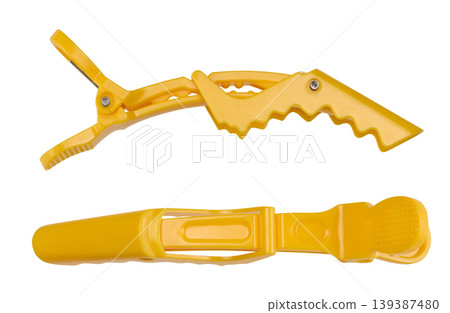 Yellow professional plastic hair clip, hairdressing tool on isolated background 139387480