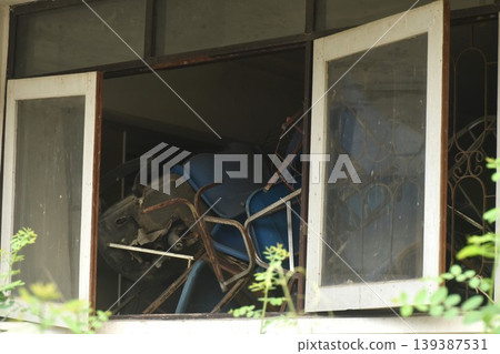 broken blue chair and table arranging block window in old school building on Thailand broken blue chair and table arranging block window in old school building on Thailand 139387531