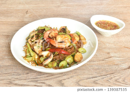stir-fried glass noodles with three stinky vegetables and shrimp couple squid on plate dipping spicy chili sauce stir-fried glass noodles with three stinky vegetables and shrimp couple squid on plate dipping spicy chili sauce 139387535