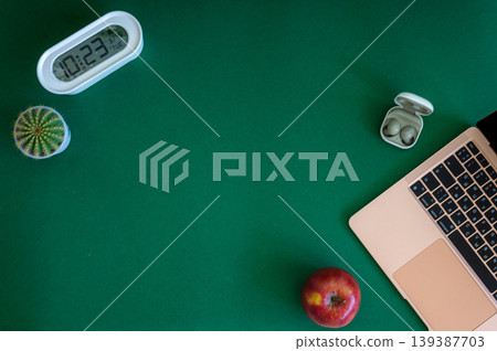 A vibrant assortment of school supplies including notebooks, pencils, markers, and scissors neatly arranged on a green background A vibrant assortment of school supplies including notebooks, pencils, markers, and scissors neatly arranged on a green background 139387703