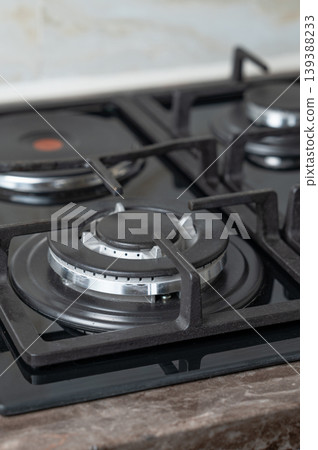 Close-up of modern gas and electric burners on a kitchen countertop. Close-up of modern gas and electric burners on a kitchen countertop. 139388233