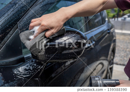 The hands of a man washing a car The hands of a man washing a car 139388390