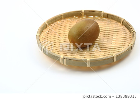 A fresh kiwi on a bamboo basket A fresh kiwi on a bamboo basket 139389315