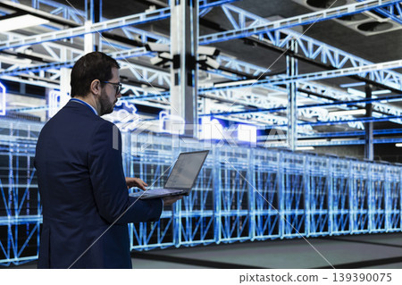 Data center programmer coding on laptop, implementing power management to reduce energy consumption. Server hub worker writing programming script on notebook, refining algorithms for faster processing 139390075