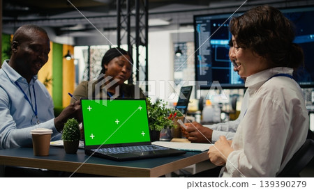 Green screen laptop used by programmers in startup office leveraging AI tech to gain competitive edge. Management doing meeting to discuss training deep learning models using mockup notebook, camera A Green screen laptop used by programmers in startup office leveraging AI tech to gain competitive edge. Management doing meeting to discuss training deep learning models using mockup notebook, camera A 139390279