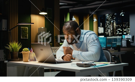 Male business manager leaning on desk showing symptoms of burnout and weariness. Sleep deprivation and work tension pushing limits with career difficulty and constant pressure. Male business manager leaning on desk showing symptoms of burnout and weariness. Sleep deprivation and work tension pushing limits with career difficulty and constant pressure. 139390309