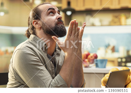 Distraught man being troubled by work mistake and failure, trying to avoid a crisis or stressful situation. Worried and anxious working from home, puzzled and scared freelancer in the kitchen. 139390531
