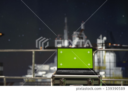 Green screen laptop on drilling rig deck used for managing operational workflows. Mockup notebook on offshore oil extraction platform used to document hazard reports after safety inspections Green screen laptop on drilling rig deck used for managing operational workflows. Mockup notebook on offshore oil extraction platform used to document hazard reports after safety inspections 139390589