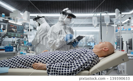 Medic in protective coveralls and gloves treats a patient in quarantine, analyzing infection data and testing vaccines to prevent outbreak spread and improve healthcare crisis. Camera A. Medic in protective coveralls and gloves treats a patient in quarantine, analyzing infection data and testing vaccines to prevent outbreak spread and improve healthcare crisis. Camera A. 139390633