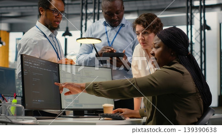 Team of software developers in office working together, automating workflows using AI. IT experts brainstorming to refine deep learning computational models for faster processing, camera B 139390638