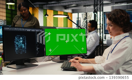 Green screen PC used by developer in office using specialized hardware to accelerate complex AI calculations. IT specialist managing deep learning training datasets with mockup computer, camera A Green screen PC used by developer in office using specialized hardware to accelerate complex AI calculations. IT specialist managing deep learning training datasets with mockup computer, camera A 139390655