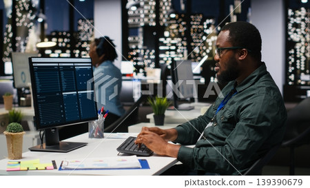 Administrator engages with financial data insights on a computer late at night, developing innovative solutions and aligning project goals with company objectives. Corporate environment. Administrator engages with financial data insights on a computer late at night, developing innovative solutions and aligning project goals with company objectives. Corporate environment. 139390679