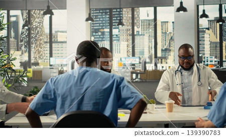Doctors and nurses in a professional meeting discussing treatment strategies and diagnosis plans. Diverse healthcare team collaborates on innovation and patient care solutions in office. Doctors and nurses in a professional meeting discussing treatment strategies and diagnosis plans. Diverse healthcare team collaborates on innovation and patient care solutions in office. 139390783