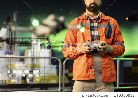 Close up of drone used by environmental officer on offshore platform for aerial surveillance of surrounding ocean waters. Worker monitoring potential oil spills or environmental hazards with UAV 139390832
