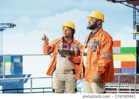Environmental officers inspect offshore platform equipment carbon footprint. Drilling rig employees evaluate spill prevention infrastructure systems to reduce ocean contamination 139390841
