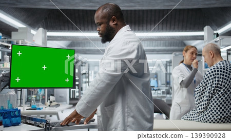 Green screen next to black medic studying data for drug testing in lab, evaluating dosage and potential side effects. Checking chemical reactions and safety to support science breakthrough. Camera A. Green screen next to black medic studying data for drug testing in lab, evaluating dosage and potential side effects. Checking chemical reactions and safety to support science breakthrough. Camera A. 139390928