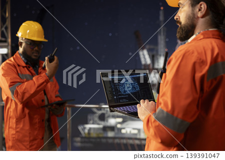 Offshore platform crew experts using neural network AI models to forecast equipment maintenance needs. Drilling rig teamworking colleagues analyze machine learning data to prevent mechanical failures Offshore platform crew experts using neural network AI models to forecast equipment maintenance needs. Drilling rig teamworking colleagues analyze machine learning data to prevent mechanical failures 139391047