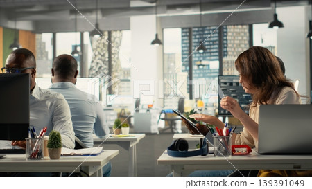 Professional people analyzing documents and graphs for risk assessment. Diverse work team collaborating on report writing and forecasting in office, executive management. 139391049