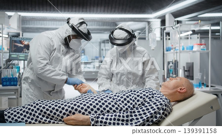Researcher in protective gear works in biohazard zone to treat a contagious patient, analyzing infection data to advance immunology and epidemic prevention in biotechnology research. Camera A. Researcher in protective gear works in biohazard zone to treat a contagious patient, analyzing infection data to advance immunology and epidemic prevention in biotechnology research. Camera A. 139391158