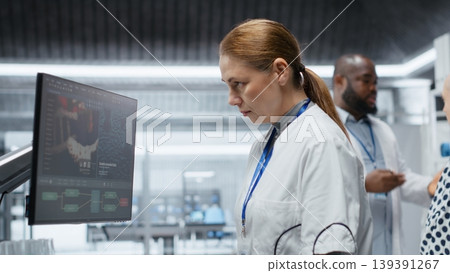 Female medic evaluates patient vitals for side effects during laboratory trial, recording dosage reactions and safety risks while supporting healthcare progress and biomedicine development. Camera B. Female medic evaluates patient vitals for side effects during laboratory trial, recording dosage reactions and safety risks while supporting healthcare progress and biomedicine development. Camera B. 139391267
