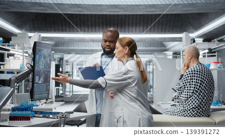 Doctors in a clinical research procedure examining DNA results on monitor, consulting a patient and studying reactions of new pills. Analyzing dosage outcomes to ensure treatment safety. Camera A. Doctors in a clinical research procedure examining DNA results on monitor, consulting a patient and studying reactions of new pills. Analyzing dosage outcomes to ensure treatment safety. Camera A. 139391272