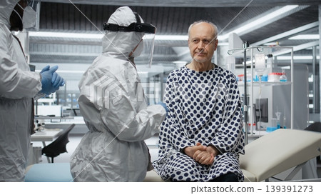 Two medics in biosafety lab perform testing on a patient infected by a virus, analyzing disease progression and treatment results. Making breakthrough with vaccine and remedy for safety. Camera A. Two medics in biosafety lab perform testing on a patient infected by a virus, analyzing disease progression and treatment results. Making breakthrough with vaccine and remedy for safety. Camera A. 139391273