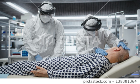 Doctors team in hazmat suits examining patient with infection symptoms in a secure laboratory, medical testing and diagnostics to prevent disease spread and support global healthcare. Camera A. Doctors team in hazmat suits examining patient with infection symptoms in a secure laboratory, medical testing and diagnostics to prevent disease spread and support global healthcare. Camera A. 139391364