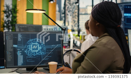 System administrators in startup office work with artificial intelligence driving market innovation. Tech agency IT specialists brainstorming to apply deep learning optimizing operations, camera B System administrators in startup office work with artificial intelligence driving market innovation. Tech agency IT specialists brainstorming to apply deep learning optimizing operations, camera B 139391375