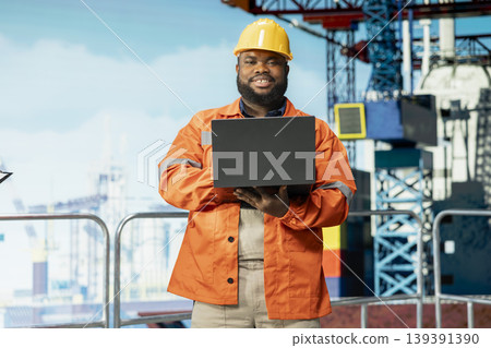 Portrait of smiling offshore platform specialist supervises deck operations, ensuring compliance with safety protocols. Joyous man working for gas company does preventative maintenance on drilling rig Portrait of smiling offshore platform specialist supervises deck operations, ensuring compliance with safety protocols. Joyous man working for gas company does preventative maintenance on drilling rig 139391390