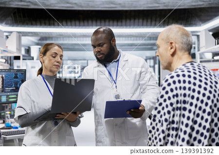 Laboratory experts analyzing a patient vitals during drug testing, evaluating treatment safety, dosage reactions and side effects in a study. Innovation and prevention in healthcare. Laboratory experts analyzing a patient vitals during drug testing, evaluating treatment safety, dosage reactions and side effects in a study. Innovation and prevention in healthcare. 139391392
