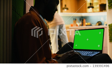 Isolated chroma key with African American man in soft light warm interior, peaceful domestic life capturing relaxation and comfort. Modern lifestyle sitting on the floor in hallway, ambiance. Isolated chroma key with African American man in soft light warm interior, peaceful domestic life capturing relaxation and comfort. Modern lifestyle sitting on the floor in hallway, ambiance. 139391496