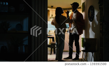 Young black people fighting in dark hallway looking angry and enraged during heated disagreement. Unhappy furious couple in conflict, relationship drama due to constant yelling and frustration. Young black people fighting in dark hallway looking angry and enraged during heated disagreement. Unhappy furious couple in conflict, relationship drama due to constant yelling and frustration. 139391500
