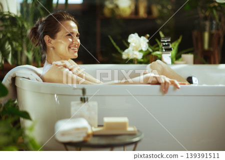 Joyful Woman Enjoying a Soothing Bubble Bath Joyful Woman Enjoying a Soothing Bubble Bath 139391511