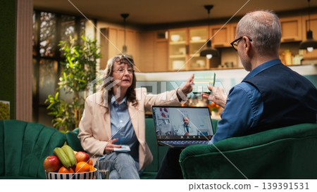 Retired man and woman on online doctor consultation with laptop. Asking about treatment and daily pills dosage via telemedicine video call, healthcare advice through e-health technology. Retired man and woman on online doctor consultation with laptop. Asking about treatment and daily pills dosage via telemedicine video call, healthcare advice through e-health technology. 139391531