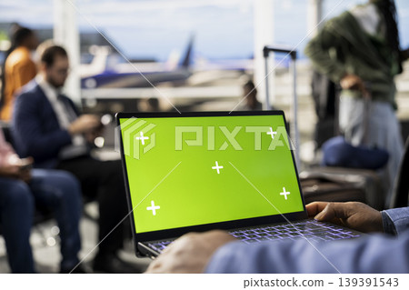 Isolated mockup on laptop in busy airport terminal with travelers ready for boarding international flight, departure for journey. Waiting area lounge with people and luggage, air travel. Isolated mockup on laptop in busy airport terminal with travelers ready for boarding international flight, departure for journey. Waiting area lounge with people and luggage, air travel. 139391543