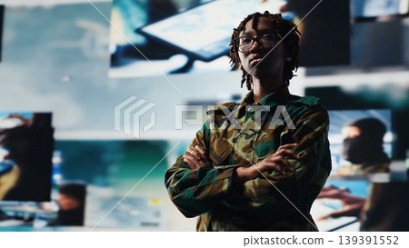 Intelligence agency specialist scanning enemy rockets using digital videowall. African american woman using radar systems on laptop program to detect incoming ballistic missiles, camera B Intelligence agency specialist scanning enemy rockets using digital videowall. African american woman using radar systems on laptop program to detect incoming ballistic missiles, camera B 139391552