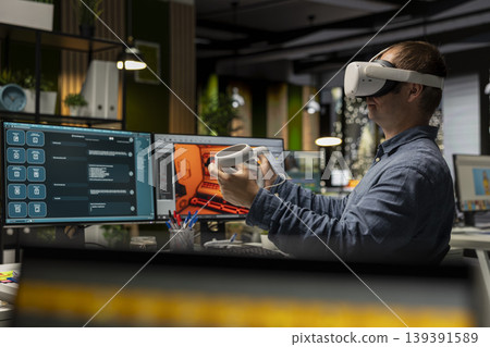 Professional engineer using VR headset and AI tech to create a spaceship for video game, moving assets in 3D program for the spatial environment. Virtual development for the internet. Professional engineer using VR headset and AI tech to create a spaceship for video game, moving assets in 3D program for the spatial environment. Virtual development for the internet. 139391589