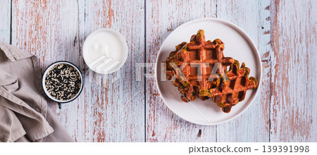 Homemade Belgian beetroot waffles on a plate on the table top view web banner Homemade Belgian beetroot waffles on a plate on the table top view web banner 139391998