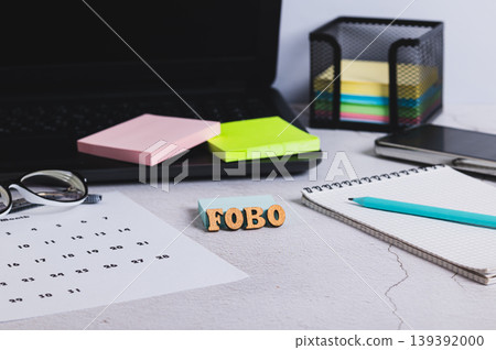 FOBO concept - Fear Of Becoming Obsolete, workplace on the table FOBO concept - Fear Of Becoming Obsolete, workplace on the table 139392000