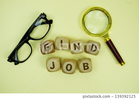 FIND JOB alphabet letters with magnifying glass and eye glasses on yellow background FIND JOB alphabet letters with magnifying glass and eye glasses on yellow background 139392125