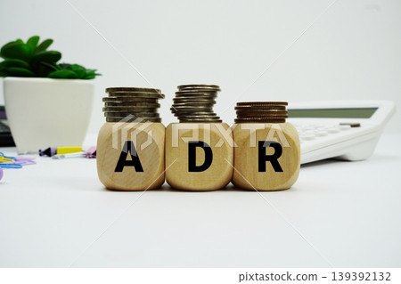 Stack of coins with wood blocks with "ADR (Average Daily Rate)" Financial concept Stack of coins with wood blocks with "ADR (Average Daily Rate)" Financial concept 139392132