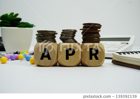 Stack of coins with wood blocks with "APR (Annual Percentage Rate)" Financial concept Stack of coins with wood blocks with "APR (Annual Percentage Rate)" Financial concept 139392139