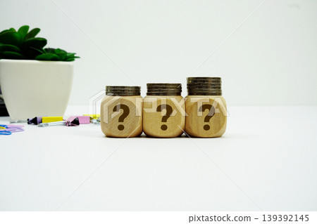 Stack of coins with wood blocks with Question Mark Financial concept Stack of coins with wood blocks with Question Mark Financial concept 139392145