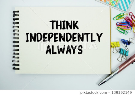 Think Independently Always text message written on notepad with stationery flat lay on white background Think Independently Always text message written on notepad with stationery flat lay on white background 139392149
