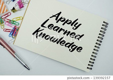 Apply Learned Knowledge text message written on notepad with stationery flat lay on white background 139392157