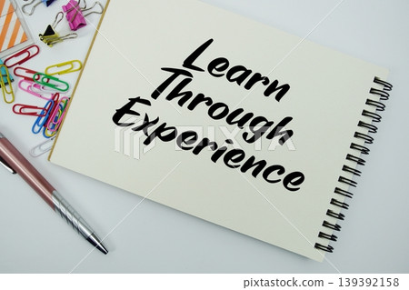 Learn Through Experience text message written on notepad with stationery flat lay on white background 139392158