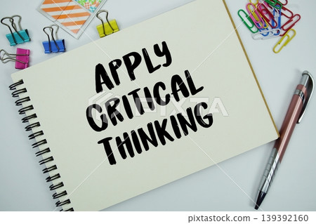 Apply Critical Thinking text message written on notepad with stationery flat lay on white background Apply Critical Thinking text message written on notepad with stationery flat lay on white background 139392160